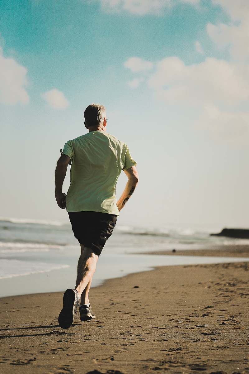 working out man running on seashore human